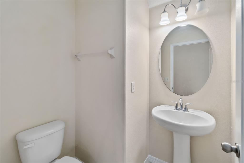 1379 Vasey Road Apopka, FL 32703 - Photo 10 of 21 a bathroom with a toilet sink and mirror