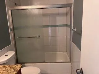 a bathroom with a shower and toilet