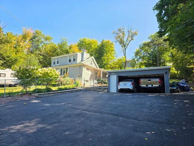 a view of a house with a yard and a garage