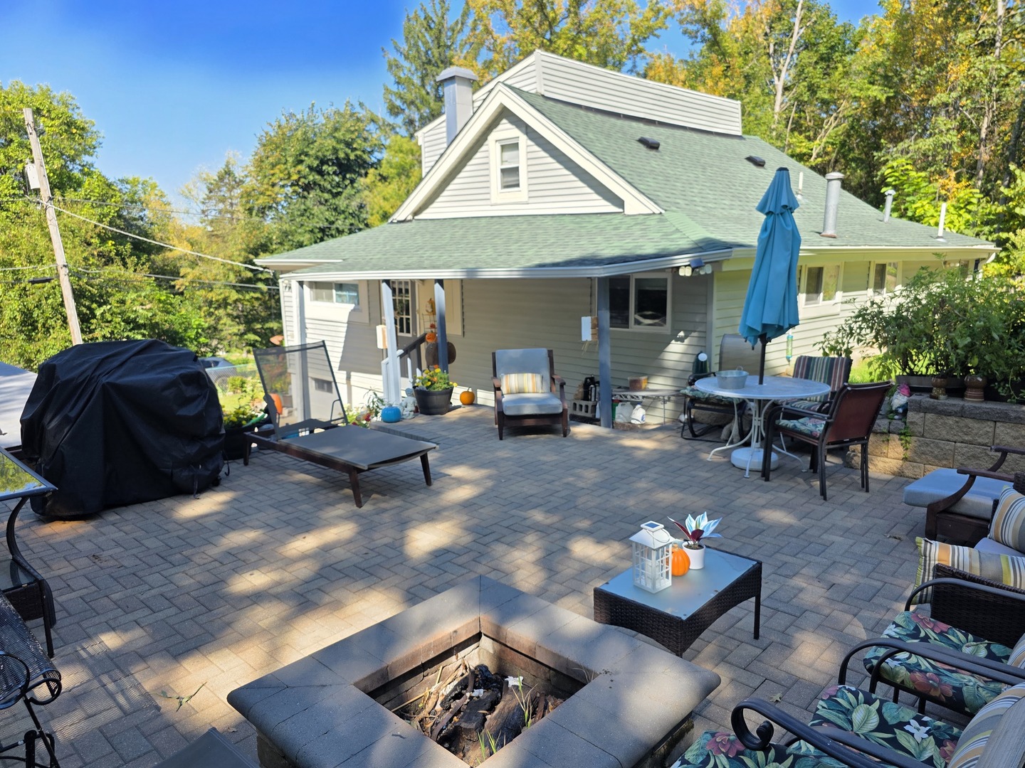 38433 North 5th Avenue Spring Grove, IL 60081 - Photo 5 of 44 a view of a patio with furniture and a fire pit