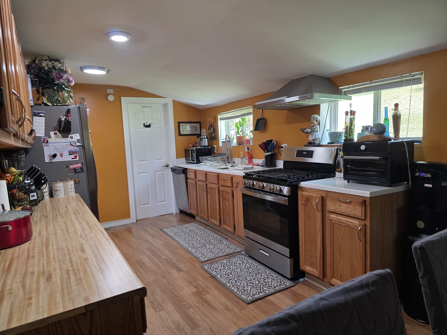 38433 North 5th Avenue Spring Grove, IL 60081 - Photo 9 of 44 a kitchen with stainless steel appliances a stove a sink a refrigerator wooden floor and cabinets