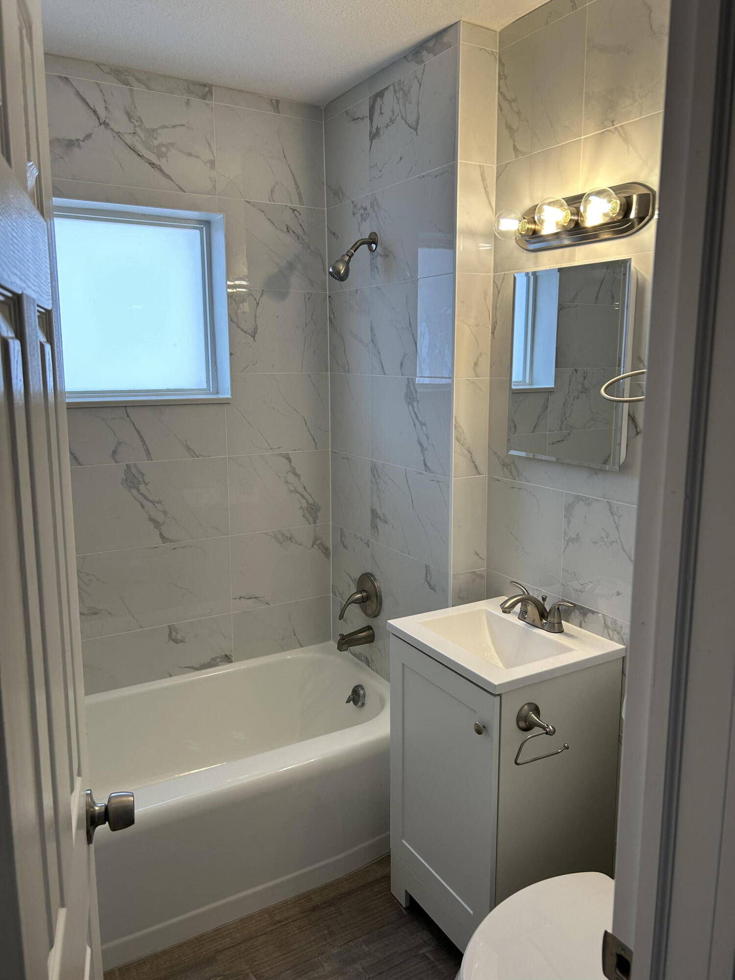 622 North M Street, Unit 3 Lake Worth Beach, FL 33460 - Photo 8 of 9 a bathroom with a sink a toilet and shower