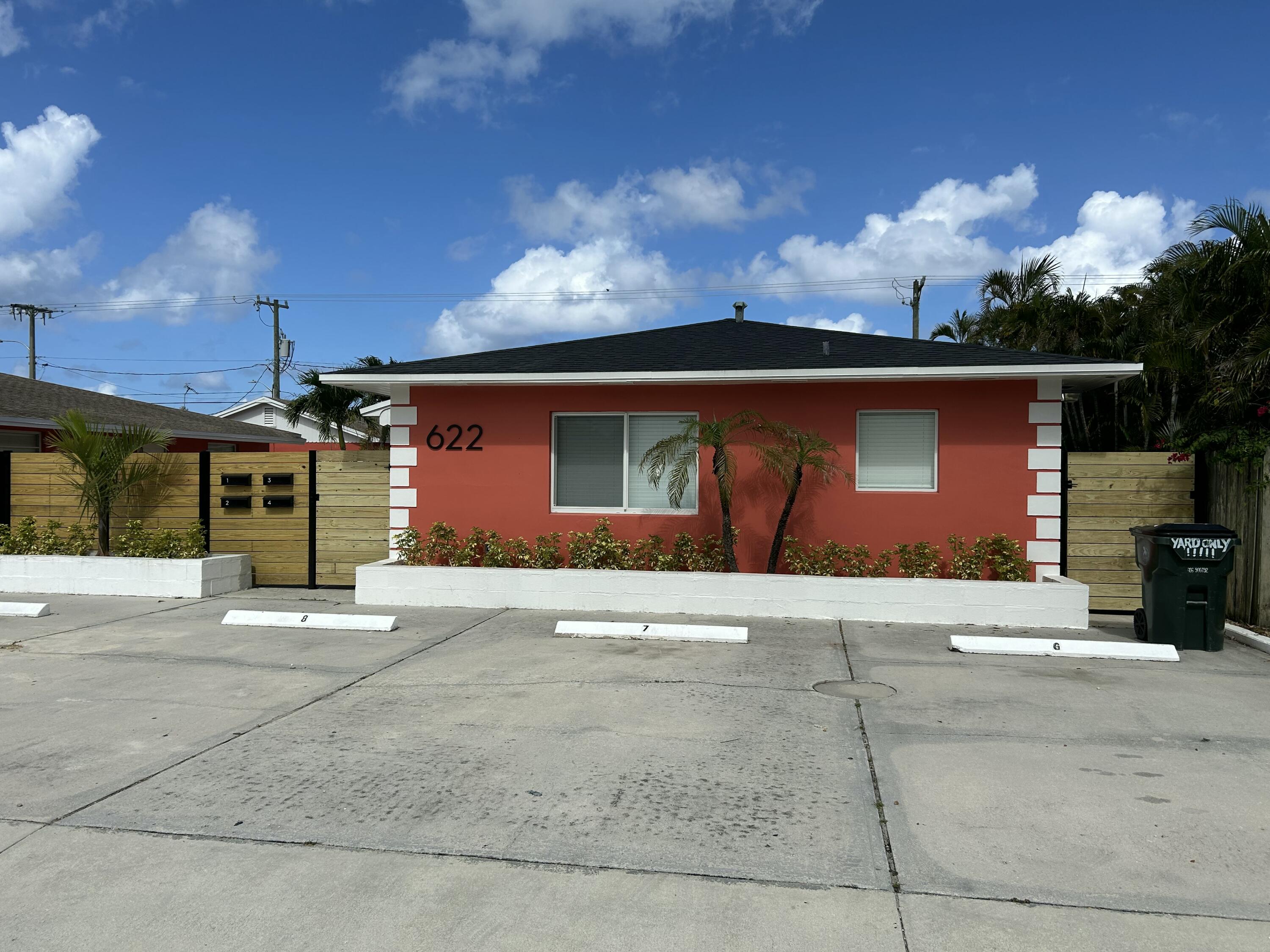 622 North M Street, Unit 3 Lake Worth Beach, FL 33460 - Photo 9 of 9 a front view of a house with a yard and garage