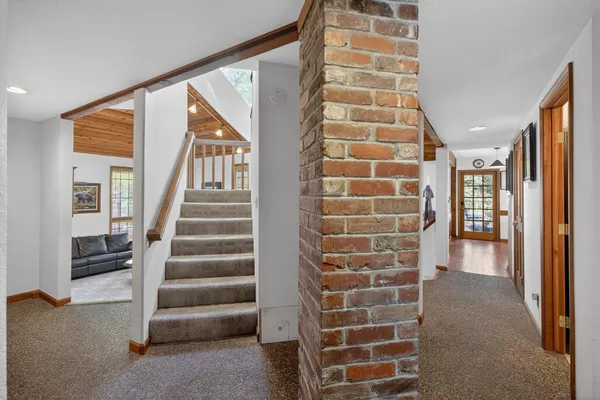 a view of a livingroom with furniture wooden floor and a fireplace