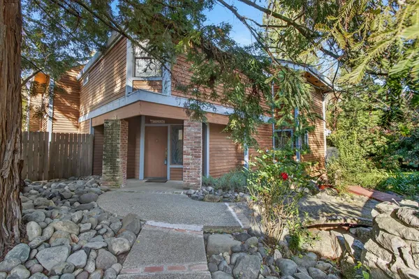 a living room with furniture a flat screen tv and a floor to ceiling window