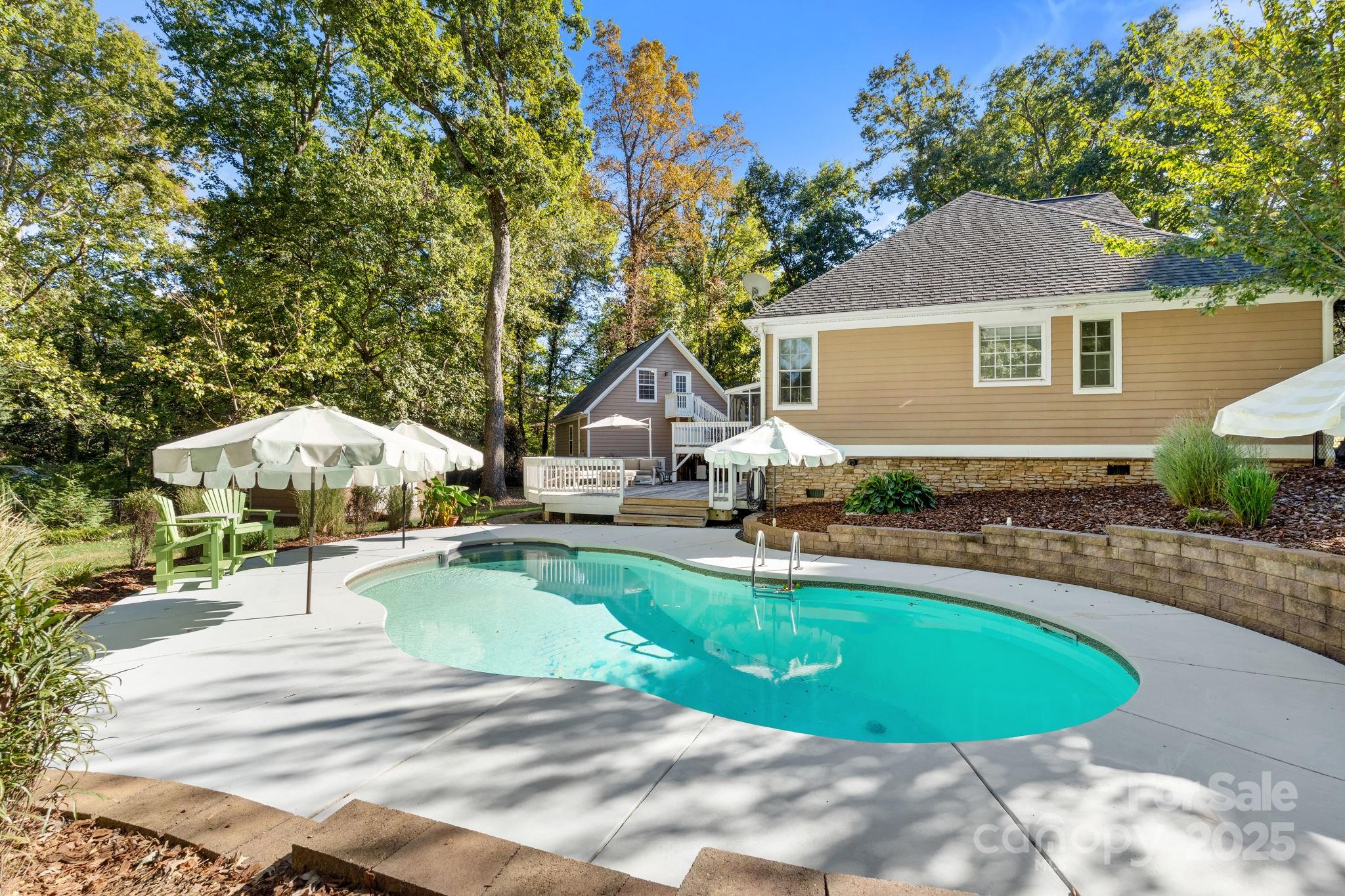 a view of a house with swimming pool and sitting area