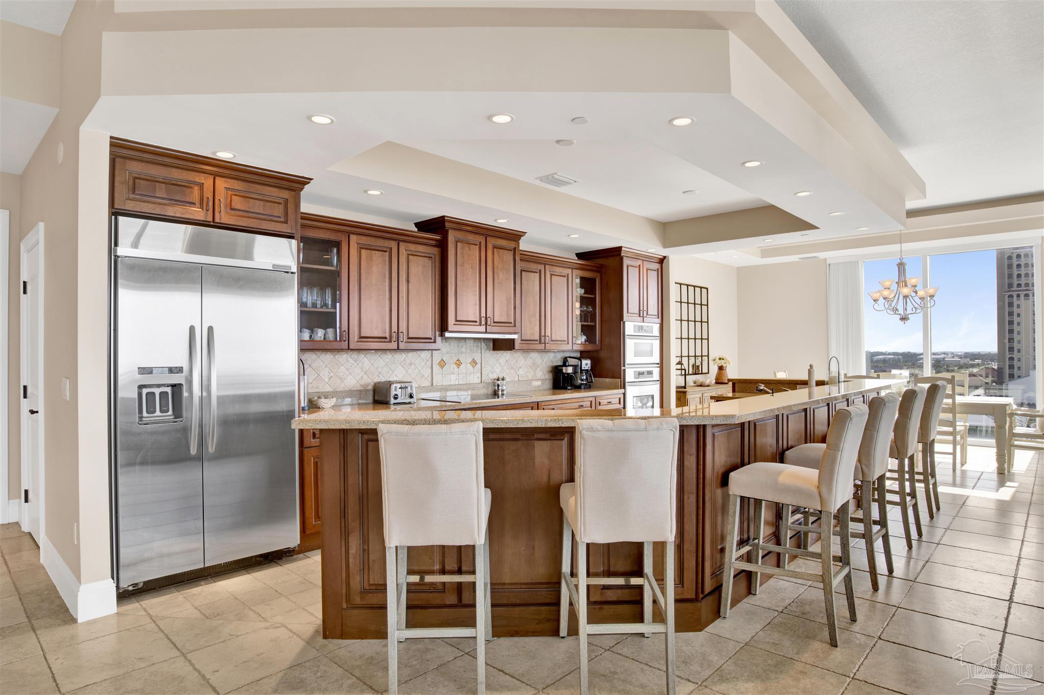 14455 Perdido Key Drive, Unit 601 Perdido Key, FL 32507 - Photo 16 of 62 a kitchen with stainless steel appliances granite countertop a table and chairs in it
