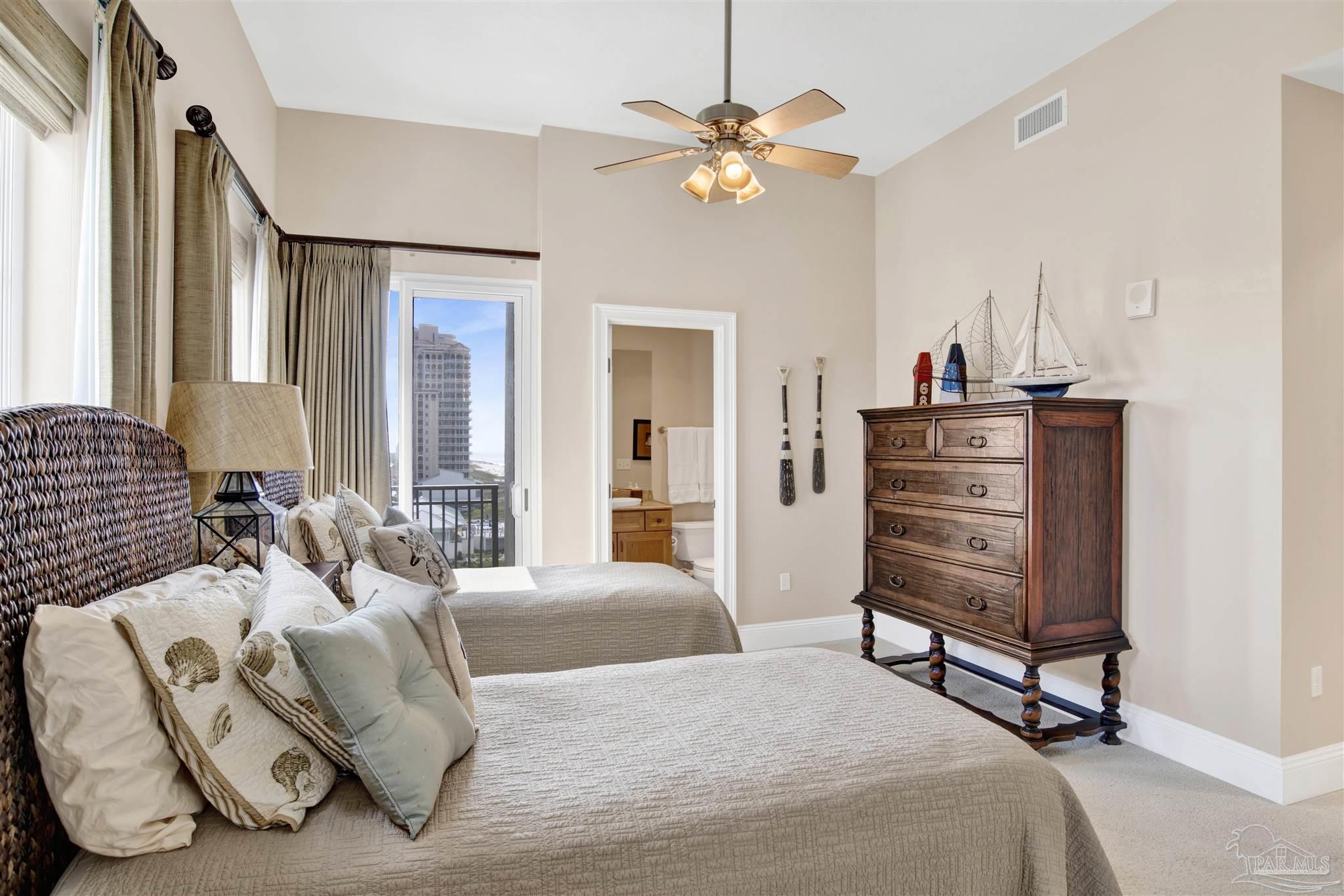 14455 Perdido Key Drive, Unit 601 Perdido Key, FL 32507 - Photo 30 of 62 a bedroom with a bed and a chandelier