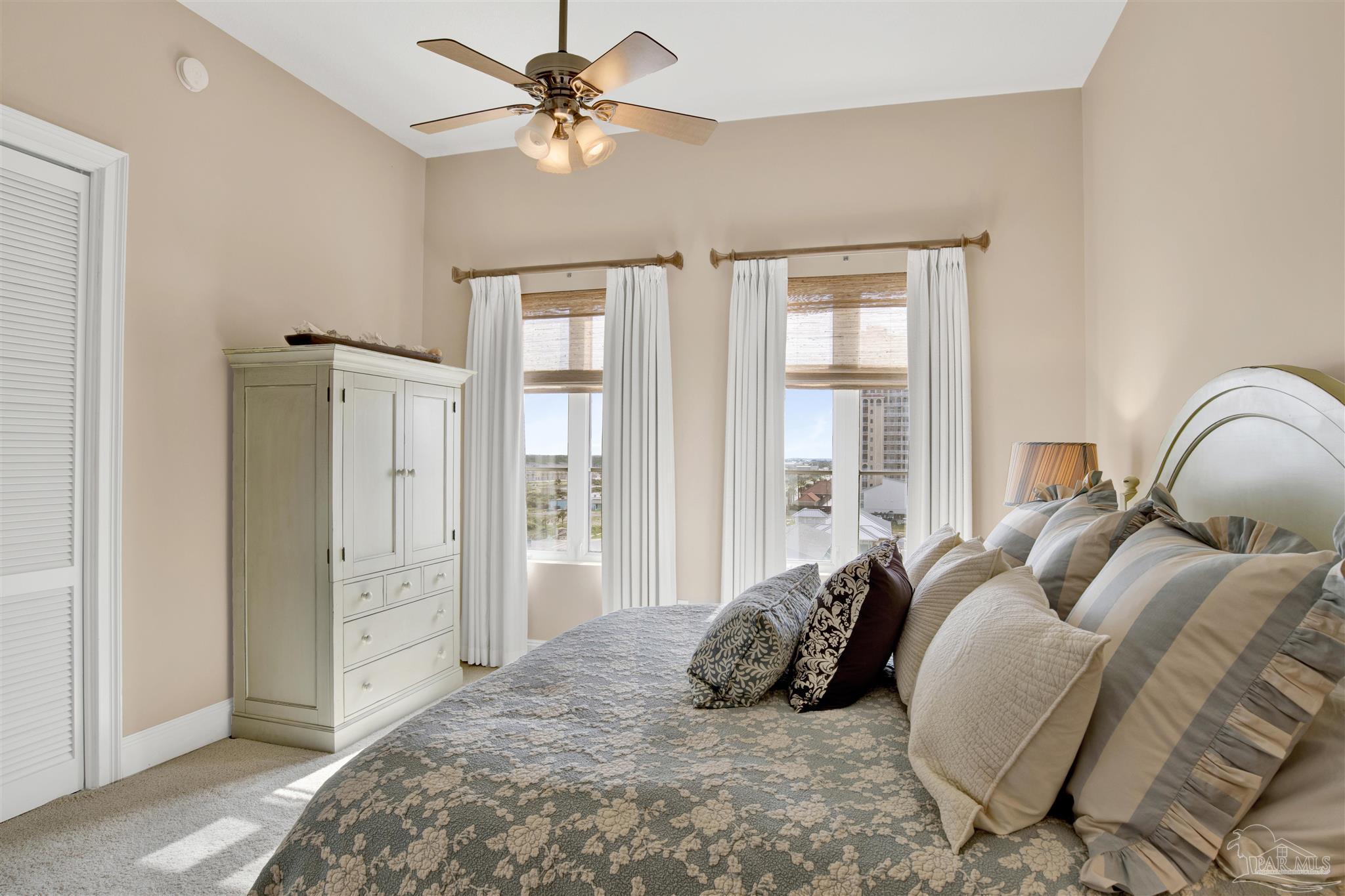 14455 Perdido Key Drive, Unit 601 Perdido Key, FL 32507 - Photo 34 of 62 a spacious bedroom with a bed and a chandelier