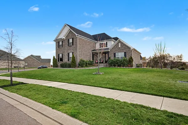 a front view of a house with a yard