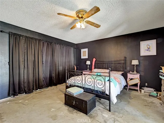 a bedroom with bed and wooden floor
