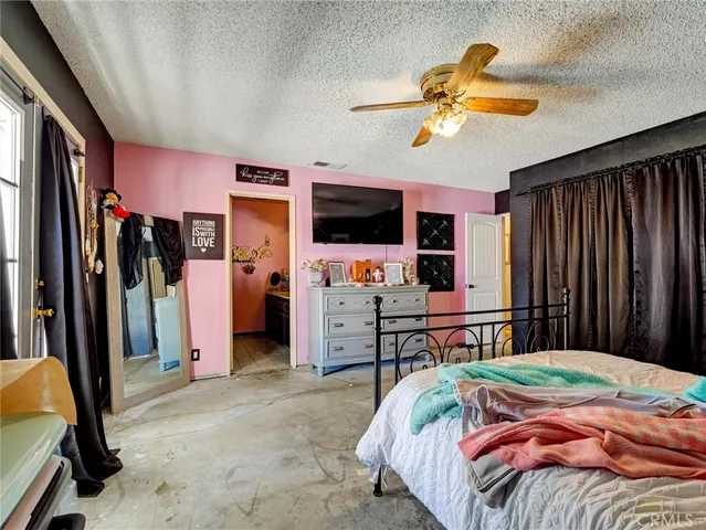 a bedroom with a bed and a flat tv screen