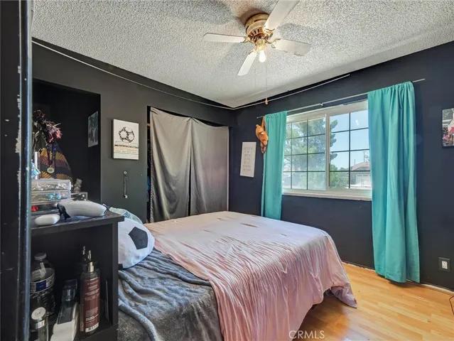 a bedroom with a large bed and a chandelier