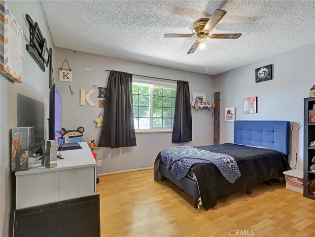 a bedroom with a bed dresser and window