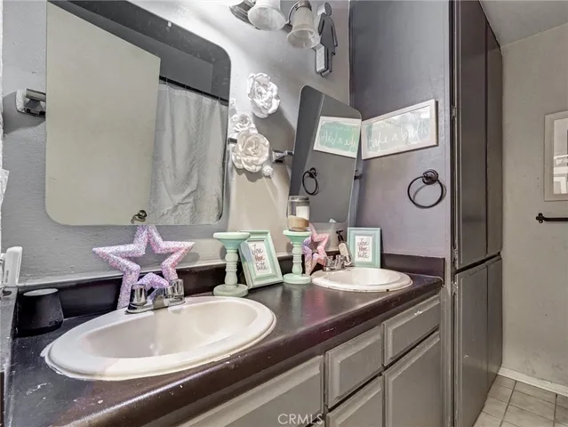 a bathroom with a granite countertop sink a mirror and a toilet