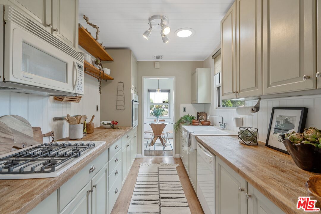 1585 Forest Avenue Pasadena, CA 91103 - Photo 11 of 28 a kitchen with a stove and a white cabinets