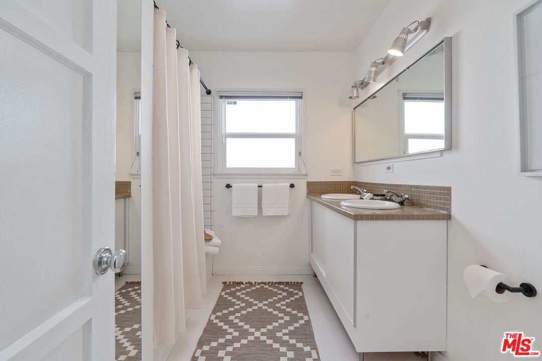 1585 Forest Avenue Pasadena, CA 91103 - Photo 17 of 28 a utility room with cabinets washer and dryer