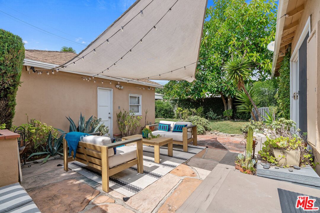 1585 Forest Avenue Pasadena, CA 91103 - Photo 19 of 28 a view of a patio with table and chairs potted plants and floor to ceiling window and potted plants