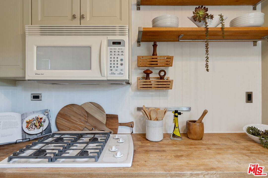 1585 Forest Avenue Pasadena, CA 91103 - Photo 10 of 28 a kitchen with a stove and a wooden floor