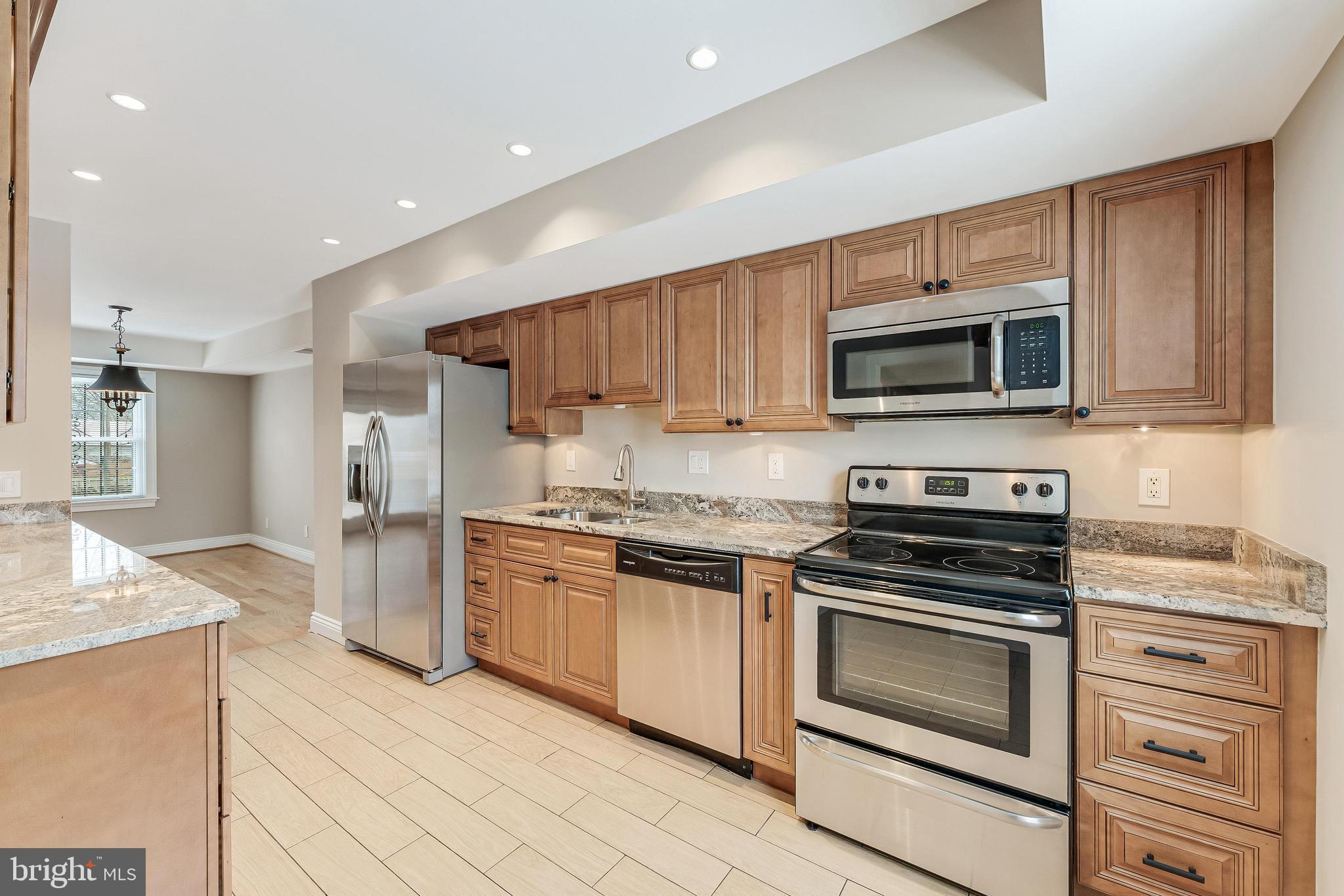 814 Geranium Street Northwest Washington, DC 20012 - Photo 15 of 51 a kitchen with stainless steel appliances granite countertop a stove top oven a sink dishwasher and a refrigerator
