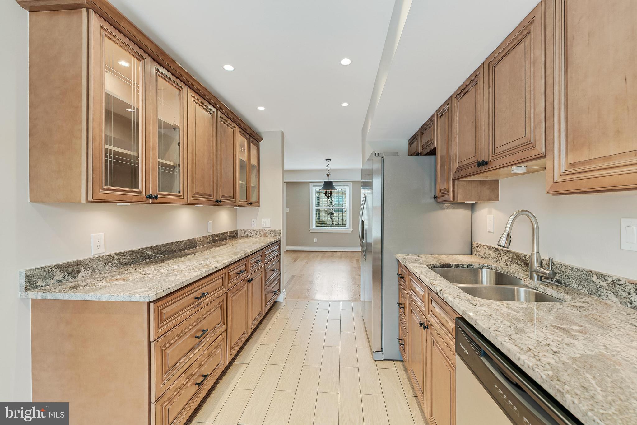 814 Geranium Street Northwest Washington, DC 20012 - Photo 16 of 51 a kitchen with stainless steel appliances granite countertop wooden cabinets a sink and dishwasher
