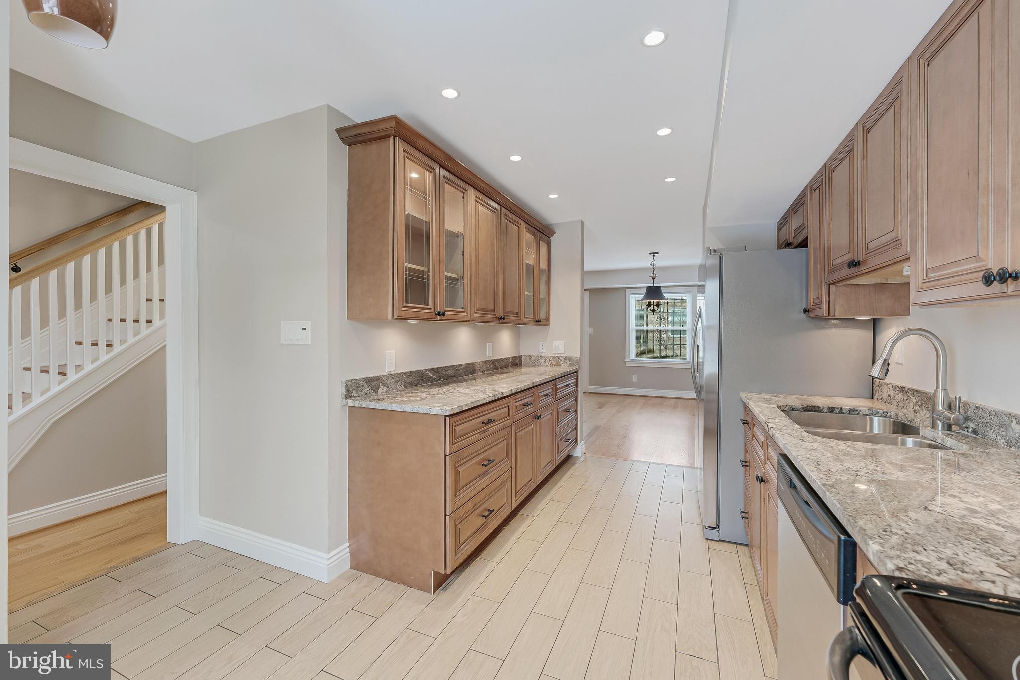 814 Geranium Street Northwest Washington, DC 20012 - Photo 19 of 51 a kitchen with stainless steel appliances granite countertop a stove a sink and a refrigerator