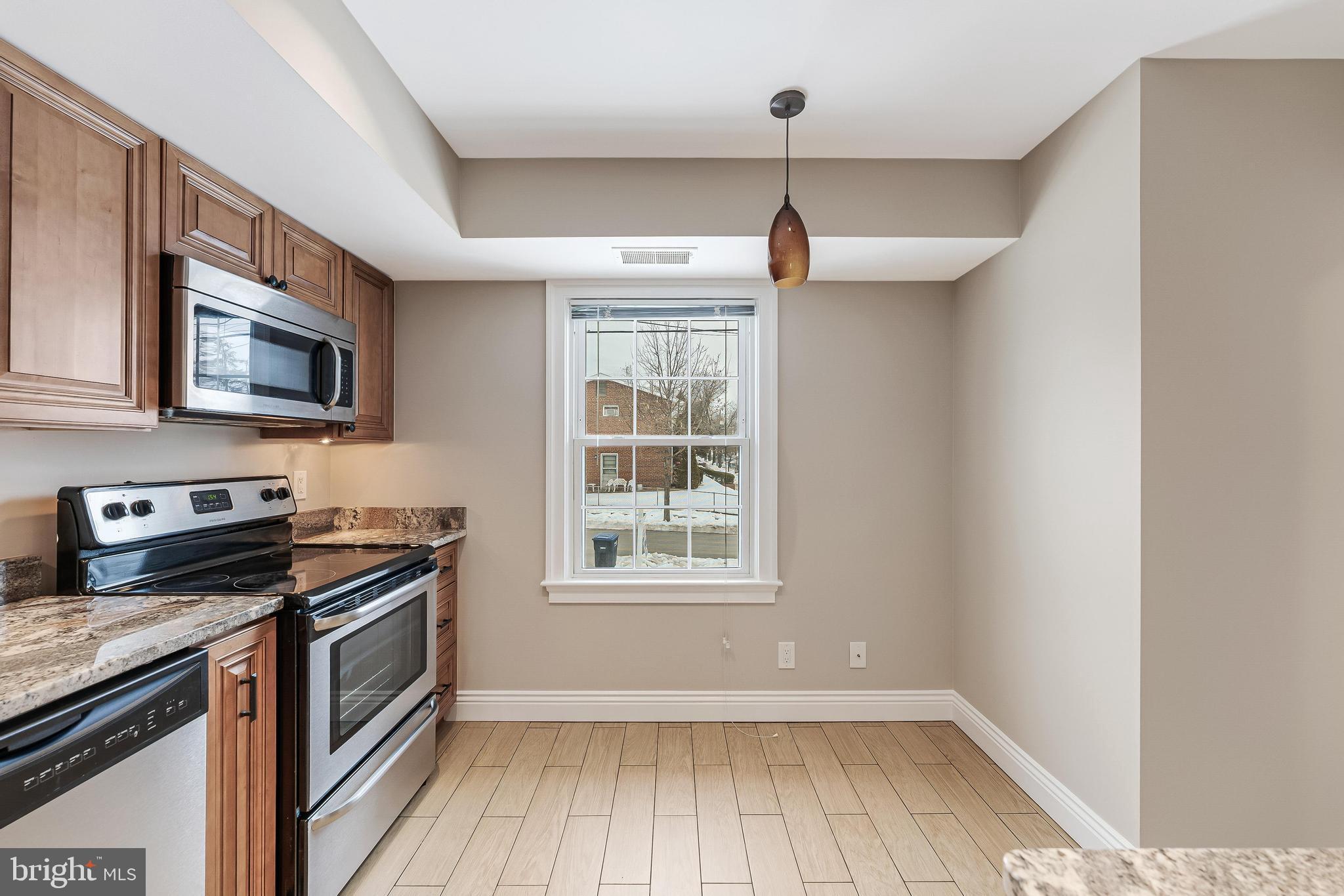 814 Geranium Street Northwest Washington, DC 20012 - Photo 20 of 51 a kitchen with a stove a microwave and window