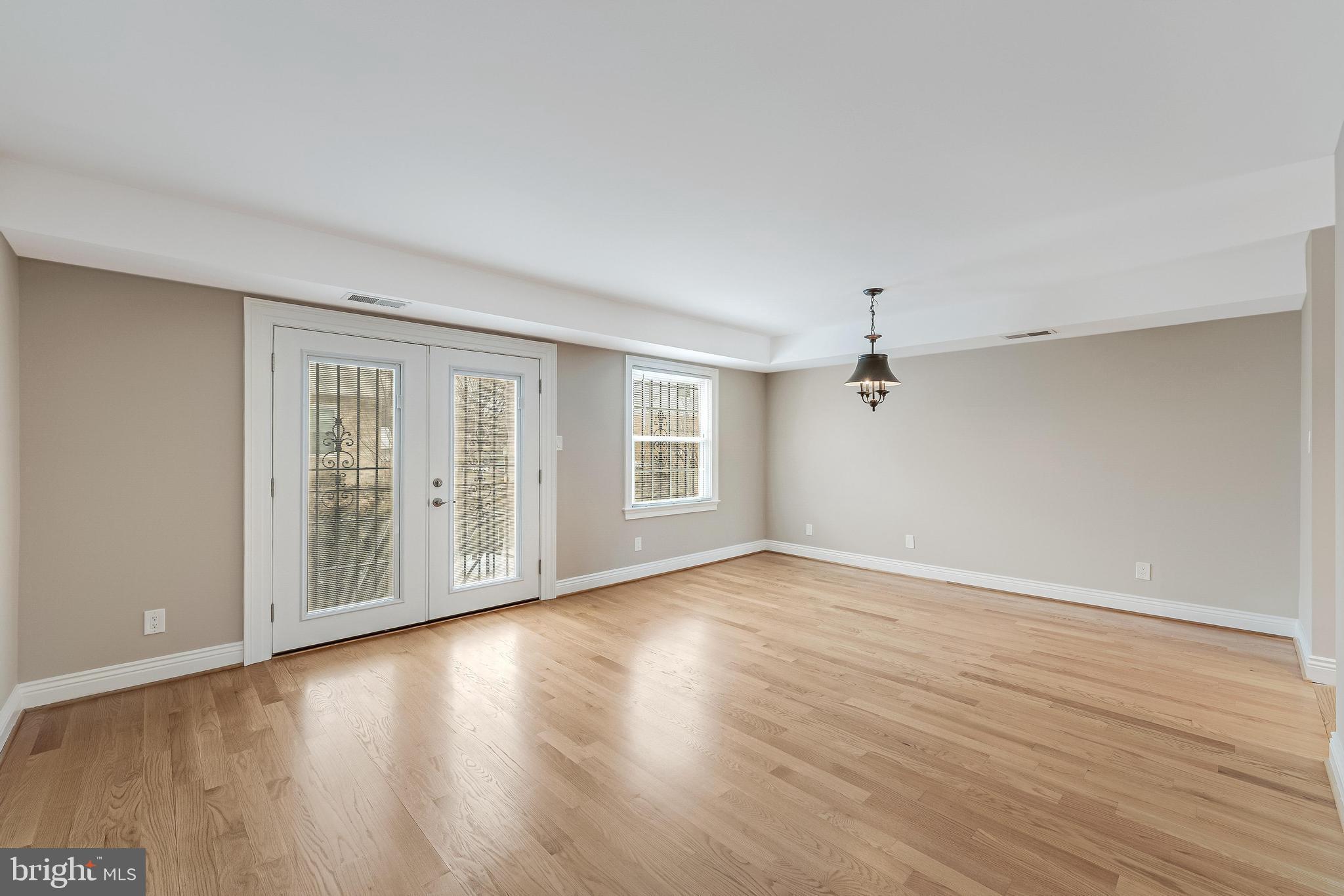 814 Geranium Street Northwest Washington, DC 20012 - Photo 22 of 51 a view of an empty room with wooden floor and a window