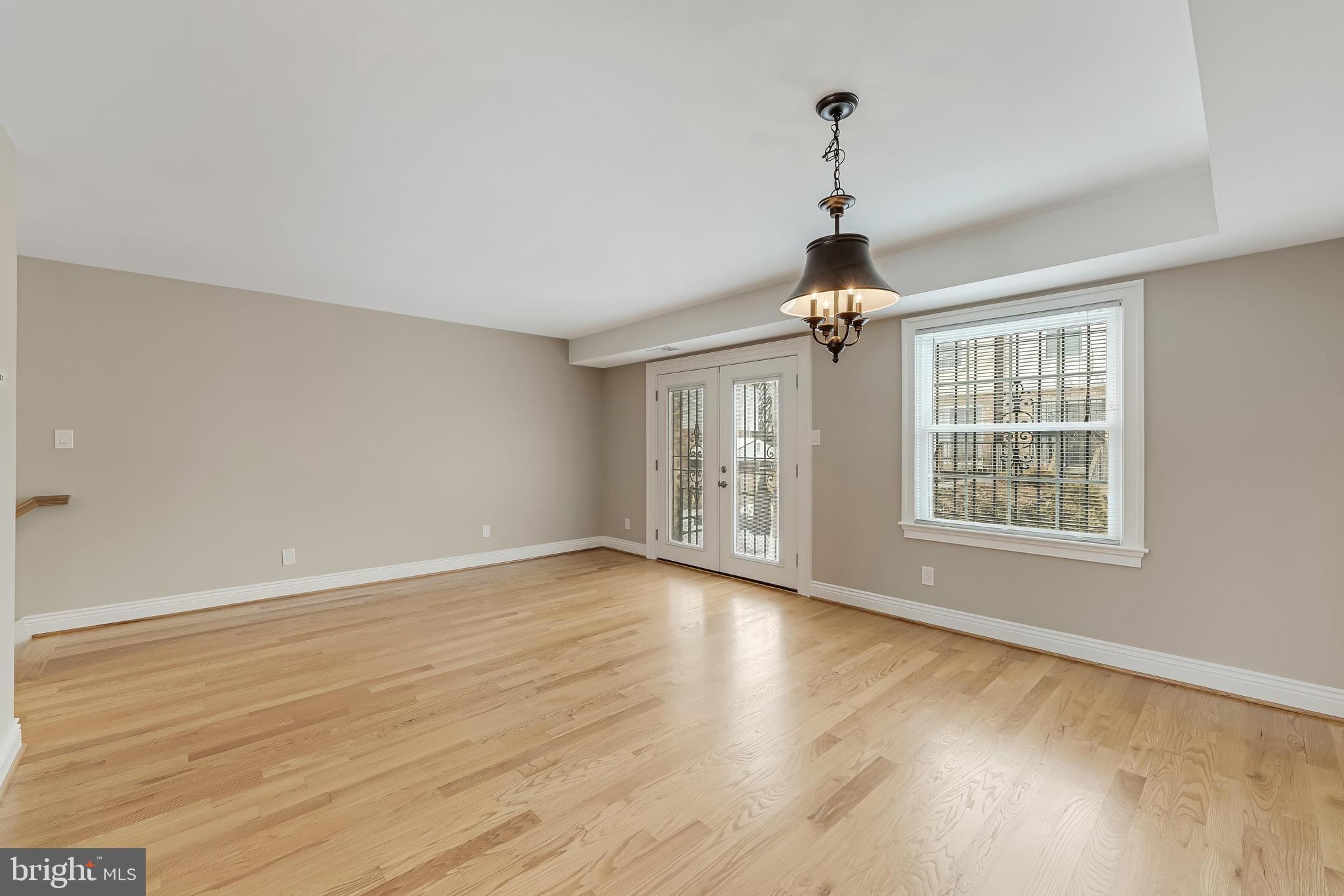 814 Geranium Street Northwest Washington, DC 20012 - Photo 25 of 51 a view of an empty room with wooden floor and a window