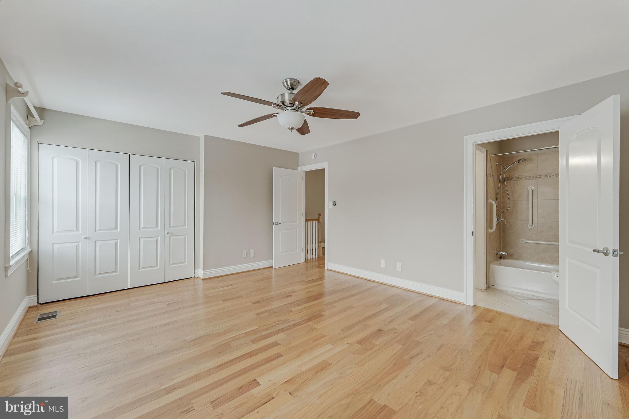 814 Geranium Street Northwest Washington, DC 20012 - Photo 30 of 51 a view of a room with wooden floor and a ceiling fan