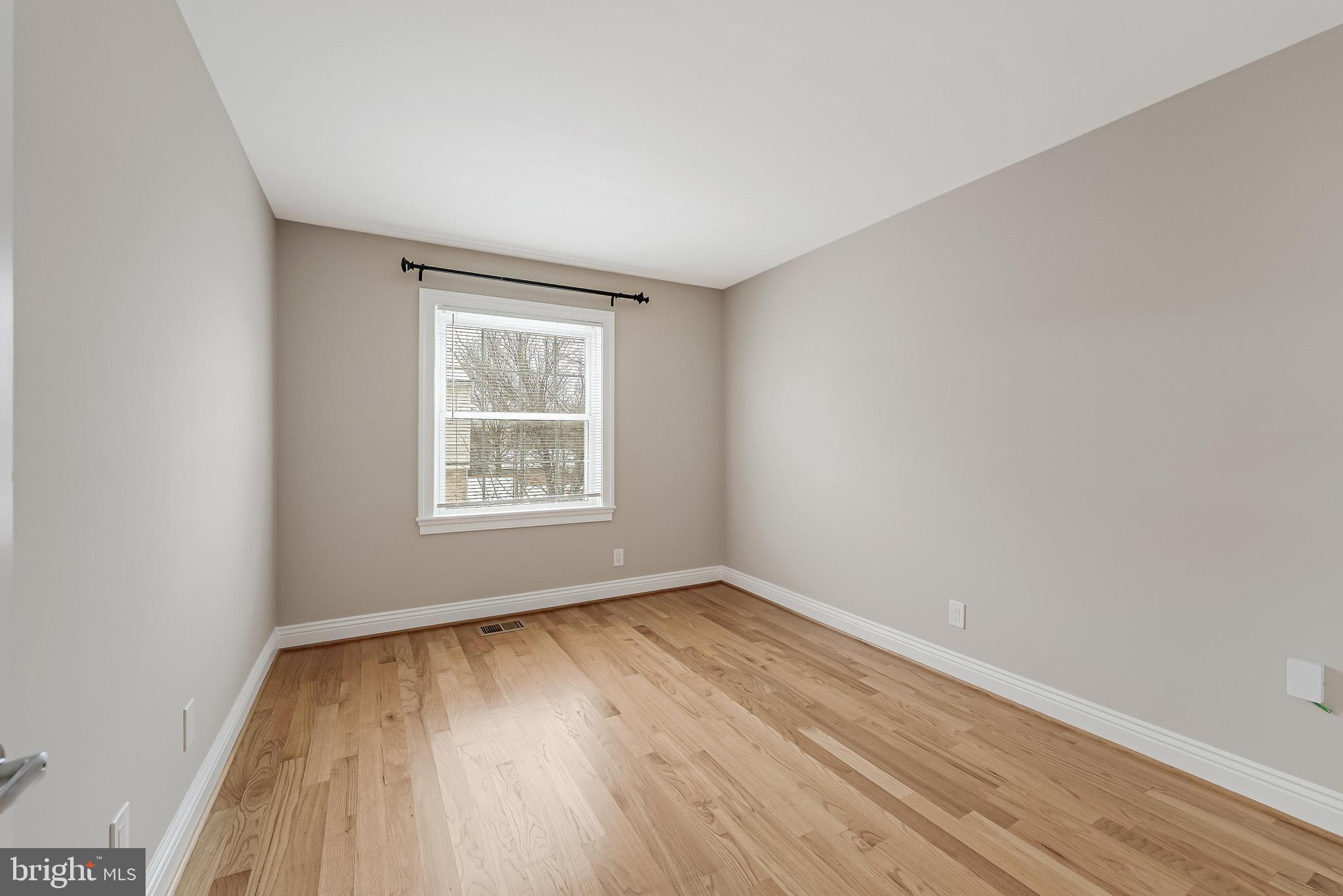 814 Geranium Street Northwest Washington, DC 20012 - Photo 32 of 51 wooden floor in an empty room with a window