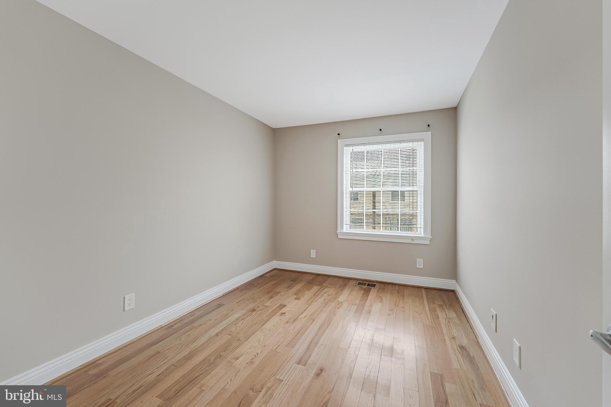 814 Geranium Street Northwest Washington, DC 20012 - Photo 35 of 51 a view of an empty room with wooden floor and a window