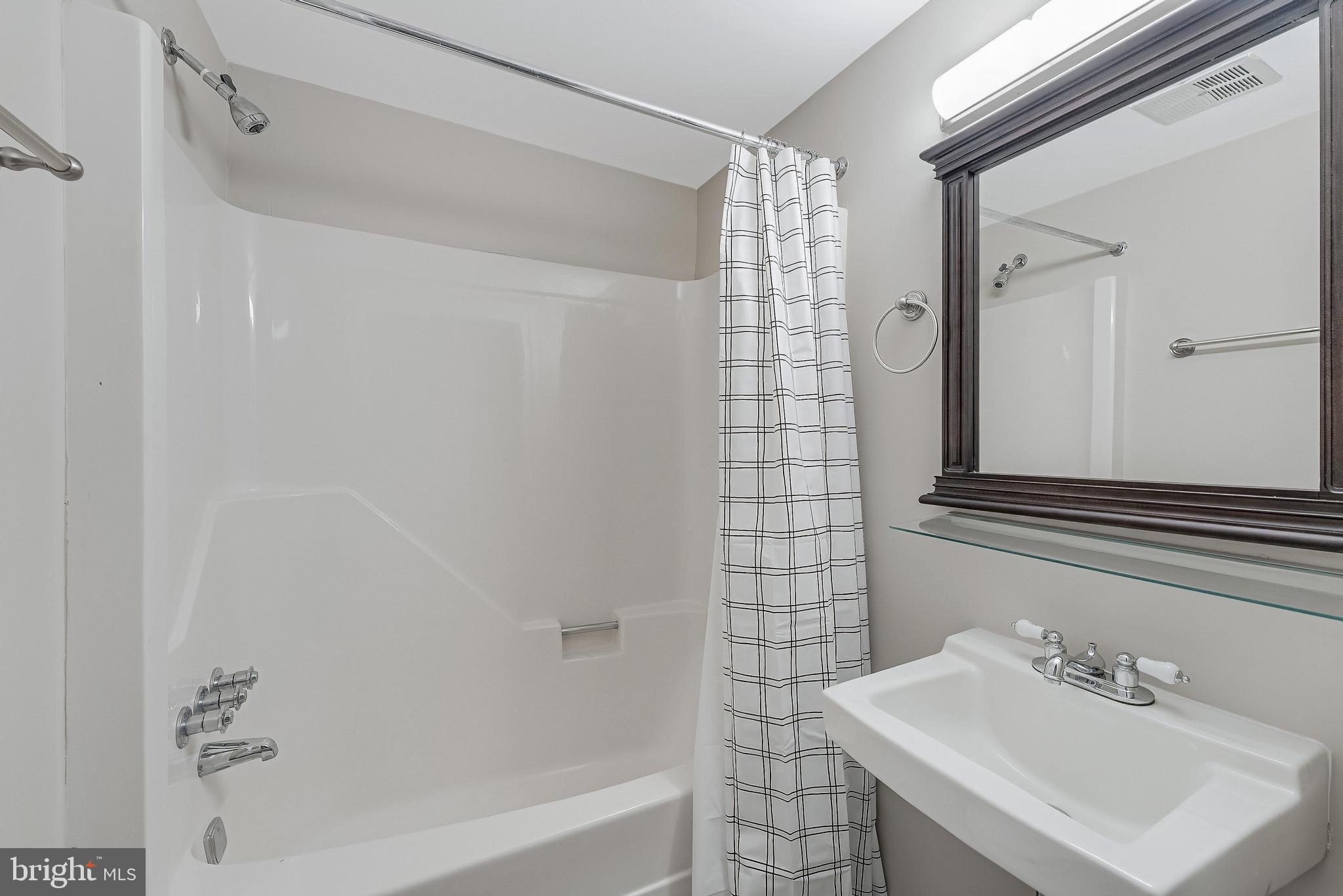 814 Geranium Street Northwest Washington, DC 20012 - Photo 47 of 51 a bathroom with a sink and a mirror