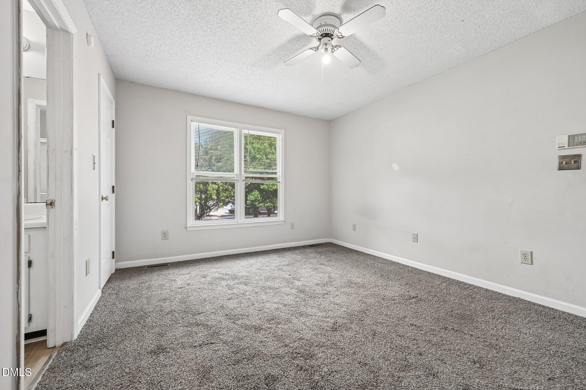 2800 West Jameson Road Raleigh, NC 27604 - Photo 13 of 24 an empty room with windows and fan
