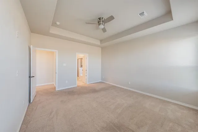 a view of a room with a ceiling fan
