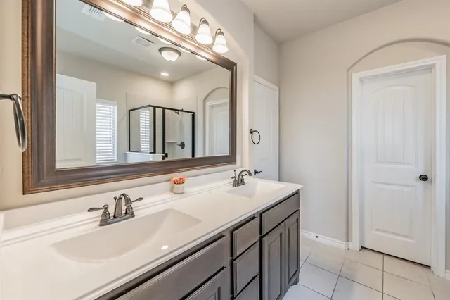 a bathroom with a sink double vanity and a mirror