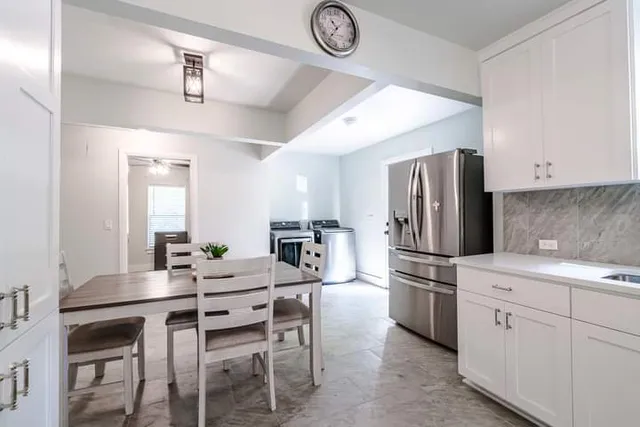 a kitchen with a dining table and chairs