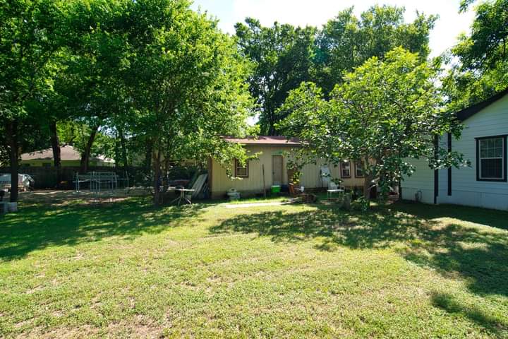 1104 Perry Road Austin, TX 78721 - Photo 8 of 15 a backyard of a house with yard and trampoline