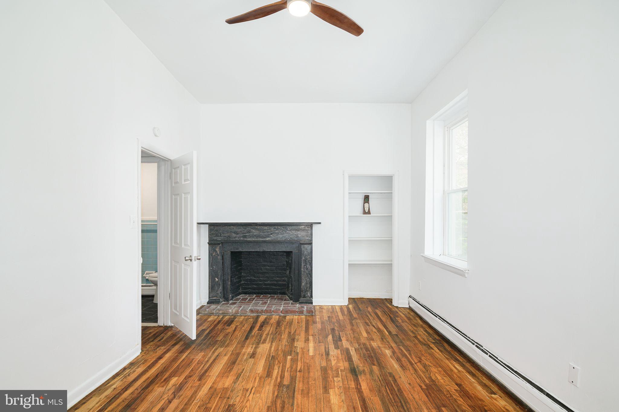 1024 Pine Street, Unit 2 Philadelphia, PA 19107 - Photo 6 of 7 a view of empty room with wooden floor and fireplace