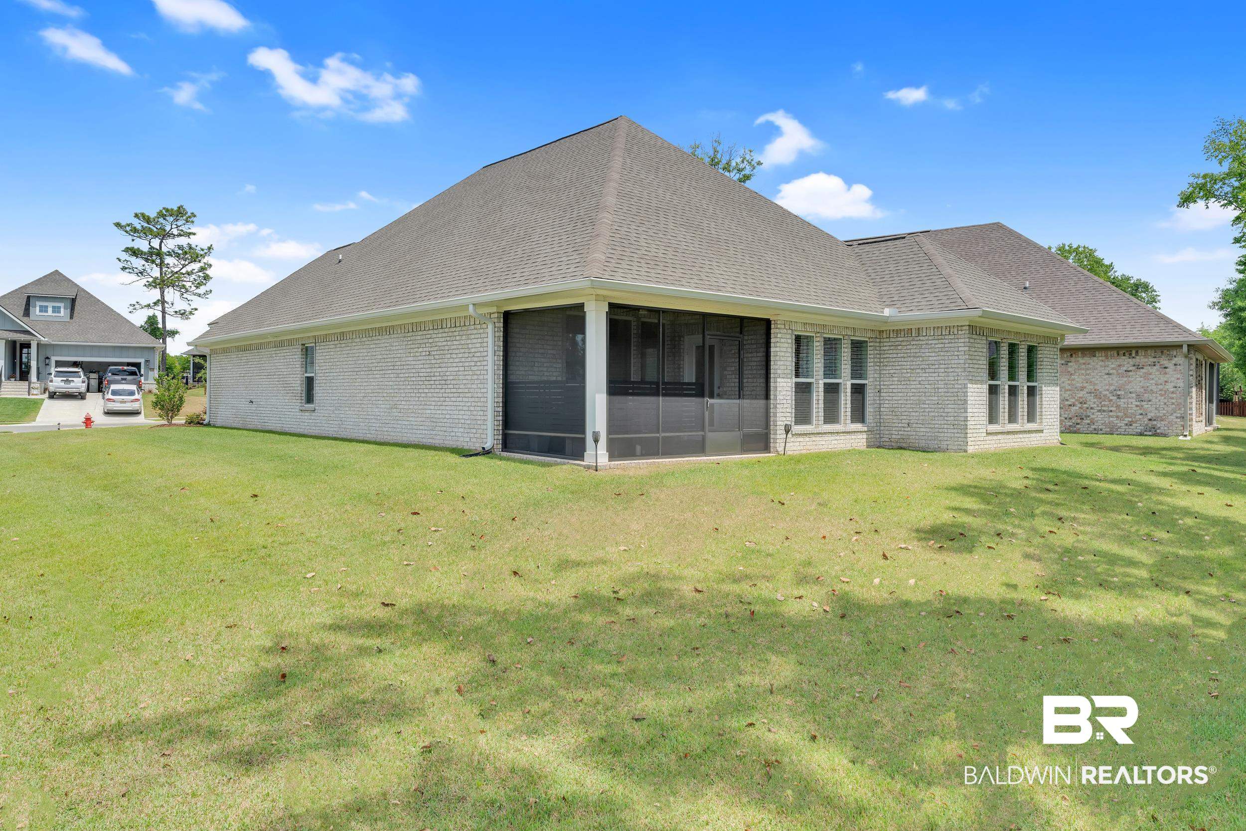31630 Canopy Loop Daphne, AL 36527 - Photo 23 of 30 Rear view of house with a yard, brick siding, a shingled roof, and a sunroom