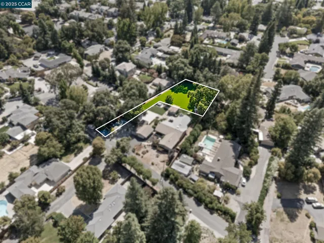 an aerial view of a house with a yard