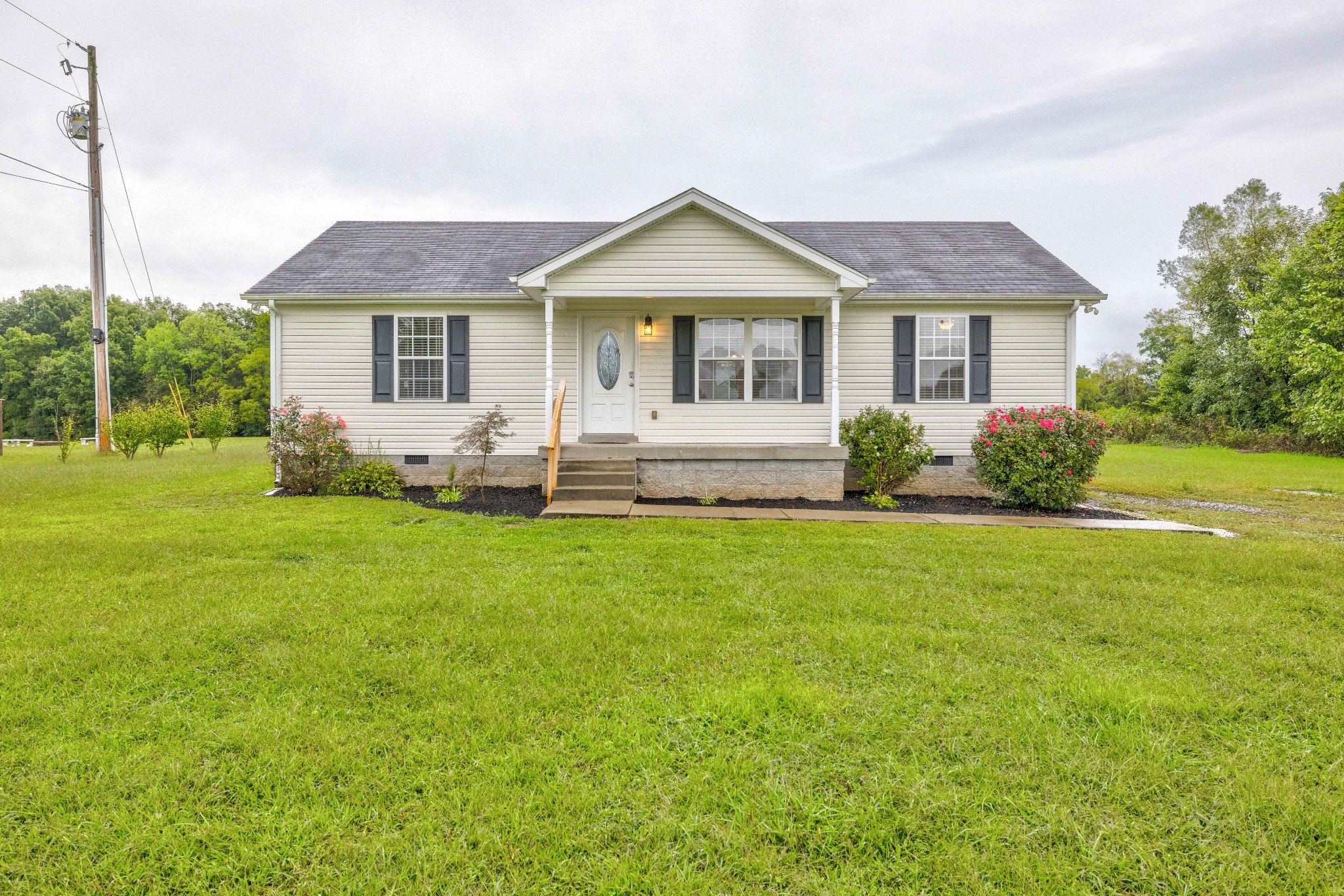 858 North Corinth Road Portland, TN 37148 - Photo 1 of 34 a front view of a house with a yard and trees