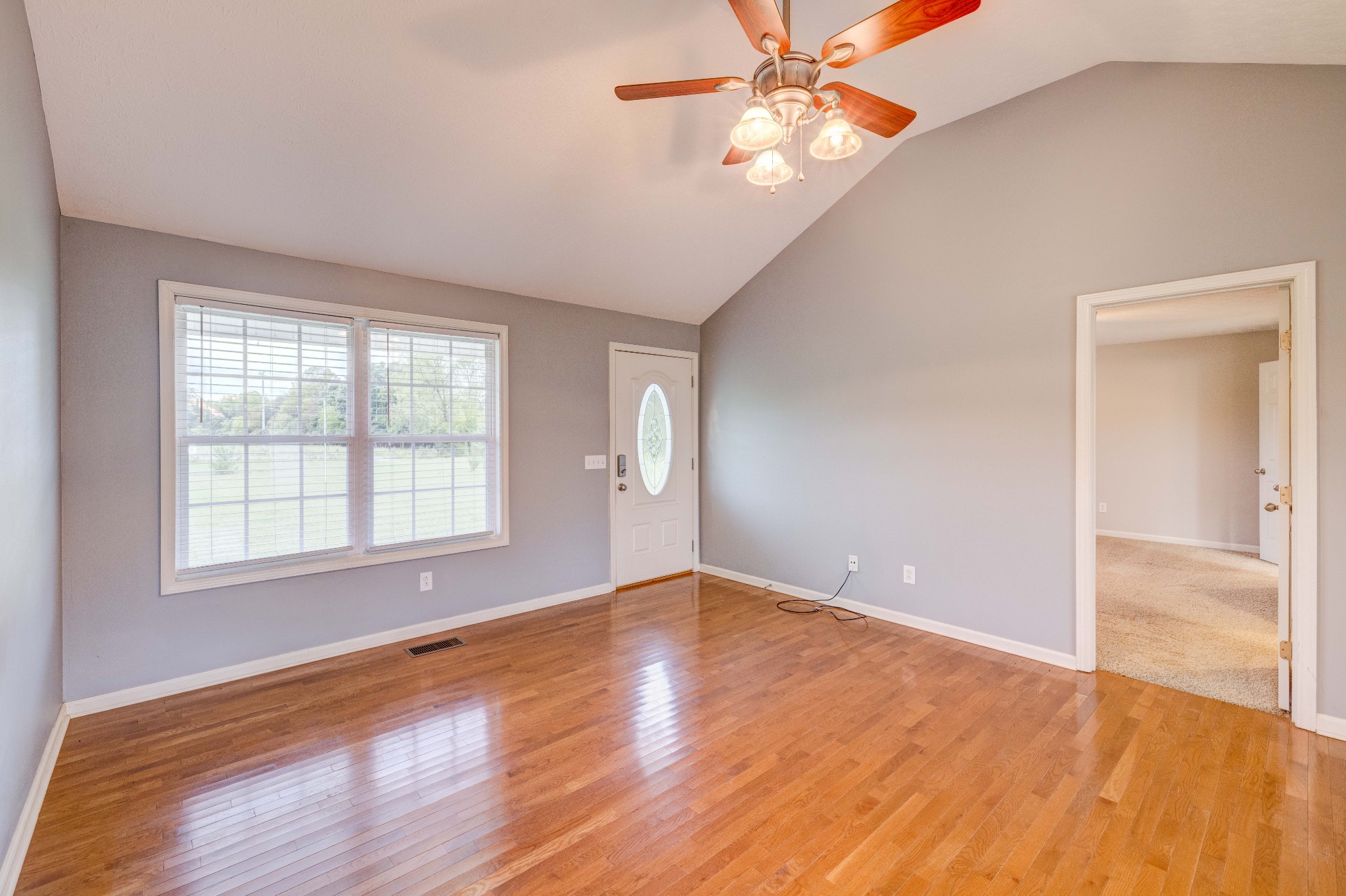 858 North Corinth Road Portland, TN 37148 - Photo 7 of 34 an empty room with wooden floor fan and windows