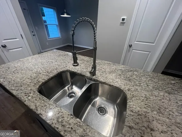a kitchen with a sink refrigerator and microwave