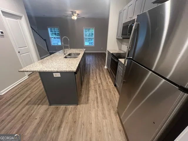 a kitchen with sink and refrigerator