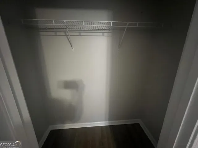 a bathroom with a granite countertop sink vanity and mirror