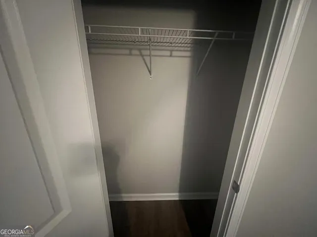 an empty room with wooden floor and entrance