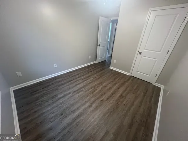 an empty room with wooden floor