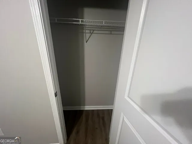 a bathroom with a granite countertop toilet and a sink