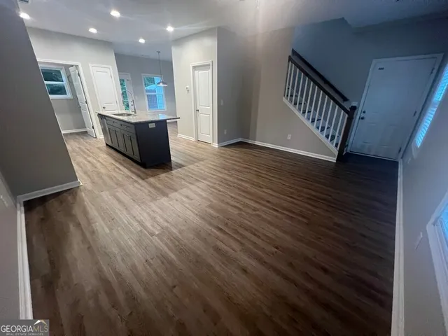 a kitchen with wooden floors and refrigerator